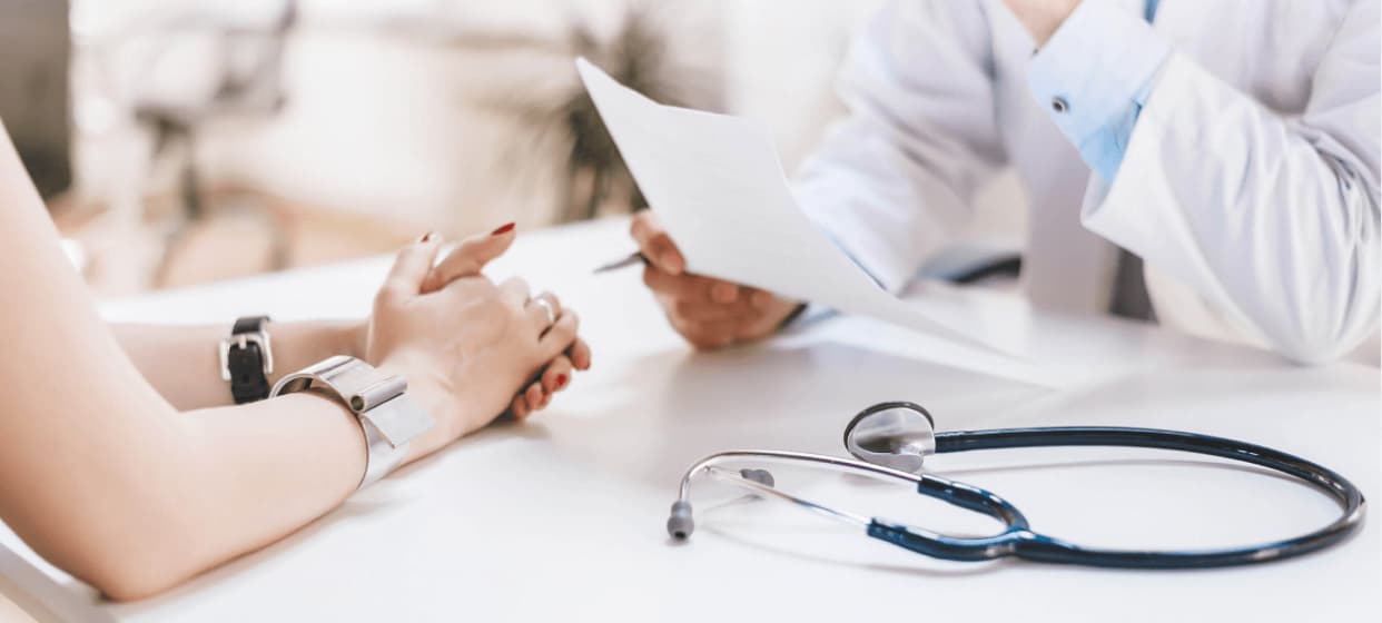 An Image of a doctor conducting routine diabetes health checkups, explaining to the patient, with a stethoscope placed on a table.
